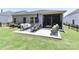 Spacious backyard with a concrete patio, outdoor furniture, and a screened-in porch at 9541 Festival Way, Charlotte, NC 28215
