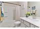 Bright bathroom with a white granite vanity and a shower and tub combo at 9541 Festival Way, Charlotte, NC 28215