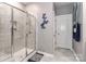 Shower room with glass doors, gray tile, and butterfly accents at 9541 Festival Way, Charlotte, NC 28215