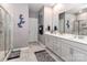 Bright bathroom with gray walls, double sinks, walk-in shower, and butterfly decor at 9541 Festival Way, Charlotte, NC 28215