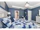 This bedroom features a decorative chandelier, blue walls, and a large bed with white trim at 9541 Festival Way, Charlotte, NC 28215