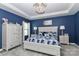 This bedroom features a decorative chandelier, blue walls, and a large bed with white trim at 9541 Festival Way, Charlotte, NC 28215