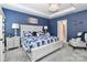 This bedroom features a decorative chandelier, blue walls, and a large bed with white trim at 9541 Festival Way, Charlotte, NC 28215