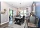 Dining room with dark wood table, modern chandelier, and natural light at 9541 Festival Way, Charlotte, NC 28215