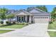 Attractive home featuring a well-kept lawn, a cozy front porch with seating, and an attached garage at 9541 Festival Way, Charlotte, NC 28215