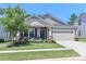 Inviting home with a lush front yard, charming porch, and an attached garage, perfect for a Gathering at 9541 Festival Way, Charlotte, NC 28215