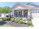 Welcoming front porch with cozy seating and decorative plants, creating a warm entrance to the home at 9541 Festival Way, Charlotte, NC 28215