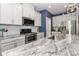 Modern kitchen features granite countertops, stainless steel appliances, and white cabinets at 9541 Festival Way, Charlotte, NC 28215