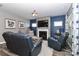 Comfortable living room features a stone fireplace, large windows, and cozy seating at 9541 Festival Way, Charlotte, NC 28215