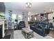 Spacious living room with dark floors, blue accent wall, and views into dining area at 9541 Festival Way, Charlotte, NC 28215