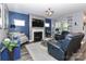 Comfortable living room features a stone fireplace, large windows, and cozy seating at 9541 Festival Way, Charlotte, NC 28215