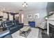 Spacious living room with dark floors, blue accent wall, and open floor plan at 9541 Festival Way, Charlotte, NC 28215