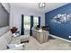 The office features dark blue accent walls and a large gray desk in front of the window at 9541 Festival Way, Charlotte, NC 28215
