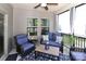 Inviting screened-in porch with ceiling fan and modern blue wicker furniture at 9541 Festival Way, Charlotte, NC 28215
