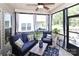 Relaxing screened-in porch with comfortable blue wicker furniture and ceiling fan at 9541 Festival Way, Charlotte, NC 28215