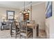 Dining room with a rustic table, unique chandelier, and a charming built-in hutch at 1007 Southwest Dr, Davidson, NC 28036