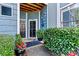 Charming front entrance featuring a decorative door, stylish lighting, and vibrant greenery at 1007 Southwest Dr, Davidson, NC 28036