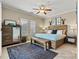 Cozy main bedroom with a wooden bed frame, bench, and ample natural light at 1007 Southwest Dr, Davidson, NC 28036