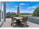 Inviting outdoor patio with dining area and serene views of the surrounding community and lake at 1007 Southwest Dr, Davidson, NC 28036