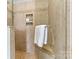 Modern tiled shower featuring shower head, seating, and toiletry storage at 1007 Southwest Dr, Davidson, NC 28036