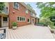 A charming red brick home features a light wood deck perfect for outdoor relaxation and entertaining at 10918 Megwood Dr, Charlotte, NC 28277