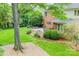 This backyard boasts a multi-tiered deck, mature trees, and lush landscaping, creating an idyllic outdoor space at 10918 Megwood Dr, Charlotte, NC 28277