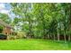An expansive backyard offers lush greenery and mature trees, creating a private and serene retreat at 10918 Megwood Dr, Charlotte, NC 28277