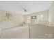 Spacious bedroom featuring a plush carpet, a bed and an accent chair at 10918 Megwood Dr, Charlotte, NC 28277