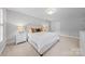 Bright bedroom with neutral walls, plush carpet, natural light and side tables at 10918 Megwood Dr, Charlotte, NC 28277