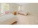 Bedroom with two twin beds with white comforters and two large windows at 10918 Megwood Dr, Charlotte, NC 28277