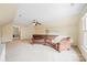 Bright bonus room with neutral walls, plush carpet and a brown sofa at 10918 Megwood Dr, Charlotte, NC 28277