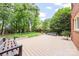 Spacious deck with bench seating and a view of the serene, tree-lined backyard at 10918 Megwood Dr, Charlotte, NC 28277