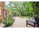 Inviting deck with bench seating, lush greenery and a view of the private backyard at 10918 Megwood Dr, Charlotte, NC 28277