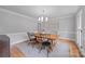 Charming dining room with hardwood floors, stylish light fixture, and four chairs at 10918 Megwood Dr, Charlotte, NC 28277