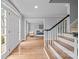 Welcoming foyer with hardwood floors, staircase, and open view to the living room at 10918 Megwood Dr, Charlotte, NC 28277