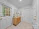 Inviting foyer with tile floors, storage cabinet, and natural light from a large window at 10918 Megwood Dr, Charlotte, NC 28277