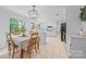 Bright kitchen with white cabinets, marble counters, and adjacent breakfast nook at 10918 Megwood Dr, Charlotte, NC 28277