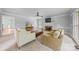 Traditional living room features fireplace, neutral palette, and bright light at 10918 Megwood Dr, Charlotte, NC 28277