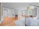 Open-concept living room with hardwood floors, neutral decor, and abundant natural light at 10918 Megwood Dr, Charlotte, NC 28277