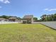 This home offers an expansive, fully fenced backyard with lush green grass, perfect for activities and relaxation at 11507 Valley Oak Ln, Stanfield, NC 28163