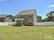 Large, fenced backyard includes a covered patio and plenty of space for outdoor activities with lush green grass at 11507 Valley Oak Ln, Stanfield, NC 28163