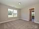 Inviting bedroom with neutral carpet, a bright window, and an open doorway at 11507 Valley Oak Ln, Stanfield, NC 28163
