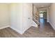 Bright foyer with wood flooring, staircase, and ample closet space, offering a welcoming entrance at 11507 Valley Oak Ln, Stanfield, NC 28163