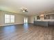 Expansive living room with wood floors, abundant natural light, and open concept layout to kitchen at 11507 Valley Oak Ln, Stanfield, NC 28163