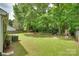 Spacious backyard featuring mature trees and a playset, perfect for Gathering activities and relaxation at 11615 Chadburn Ln, Charlotte, NC 28215