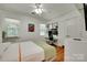 Sunlit bedroom with hardwood floors, a ceiling fan, and a dedicated workstation with built in shelving at 11615 Chadburn Ln, Charlotte, NC 28215