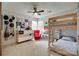 Bright bedroom features a wooden bunk bed, fun decor and an abundance of natural light from large windows at 11615 Chadburn Ln, Charlotte, NC 28215