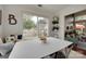 Bright breakfast nook featuring large windows, stylish decor, and a view of the fenced backyard at 11615 Chadburn Ln, Charlotte, NC 28215