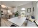 Open concept dining area adjacent to a modern kitchen, filled with natural light and stylish decor at 11615 Chadburn Ln, Charlotte, NC 28215