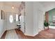Bright entryway with decorative wallpaper, shoe storage, and a leaded glass front door at 11615 Chadburn Ln, Charlotte, NC 28215
